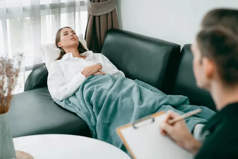 Nervous woman at grand piano, covering her face with her hand, depicting stage fright and performance anxiety
