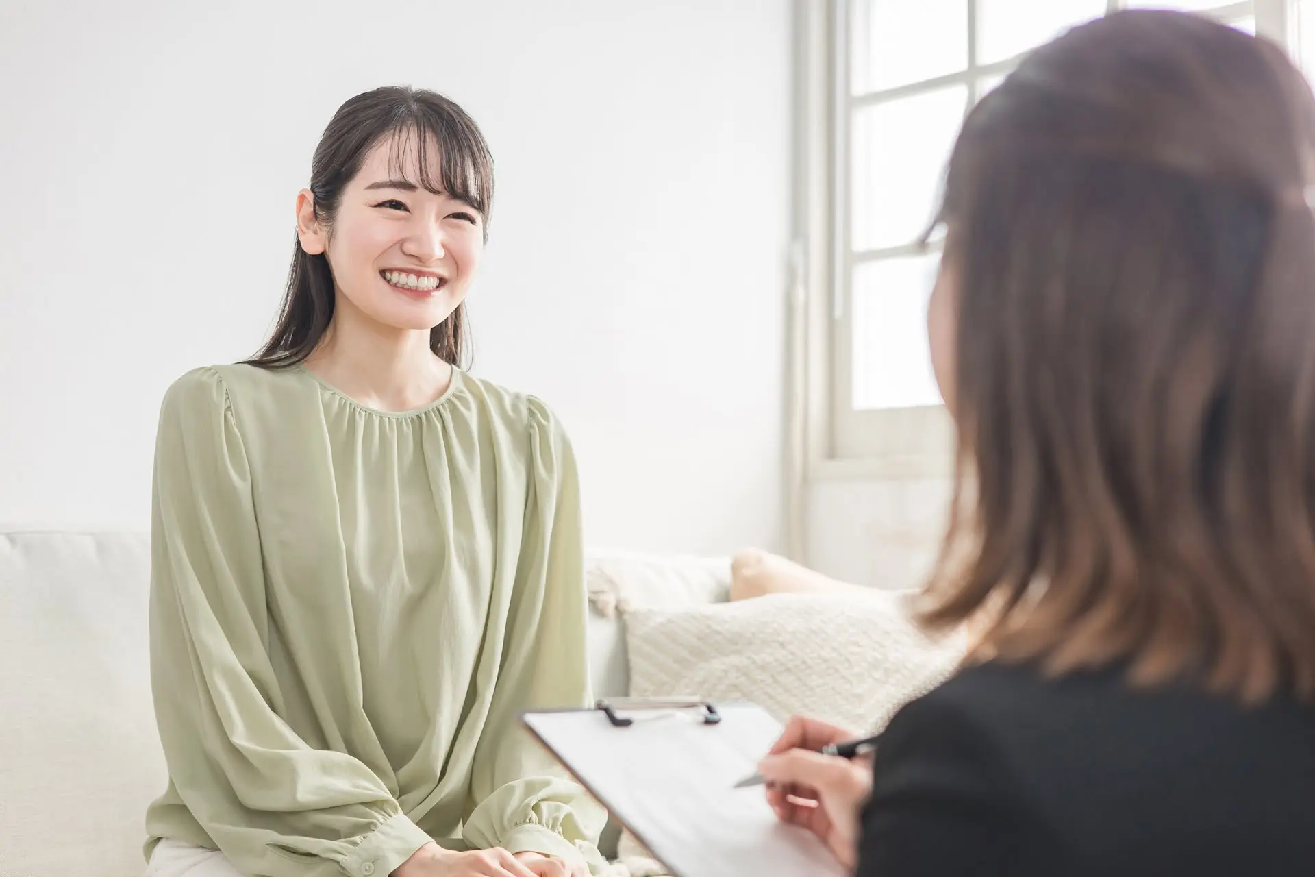 ヒプノセラピーとメンタルバンクの相乗効果を表す、落ち着いた雰囲気で話し合う二人の写真