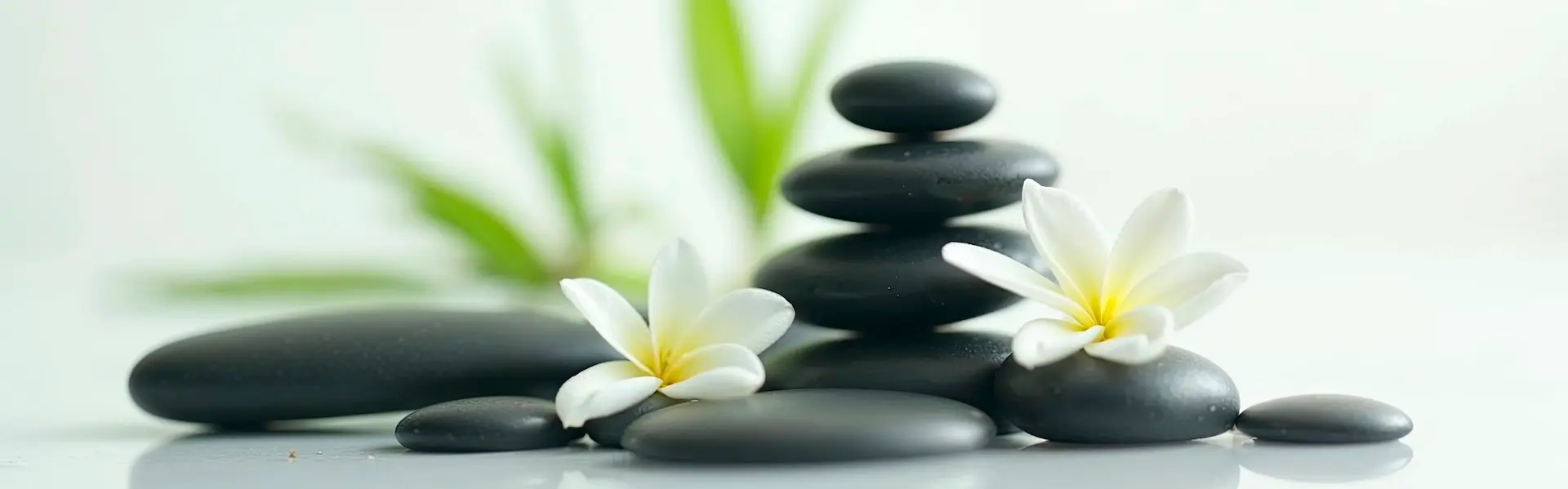 Zen stones stacked with jasmine flowers, symbolizing inner calm and self-image